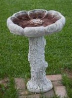 A picture of a cement bird bath