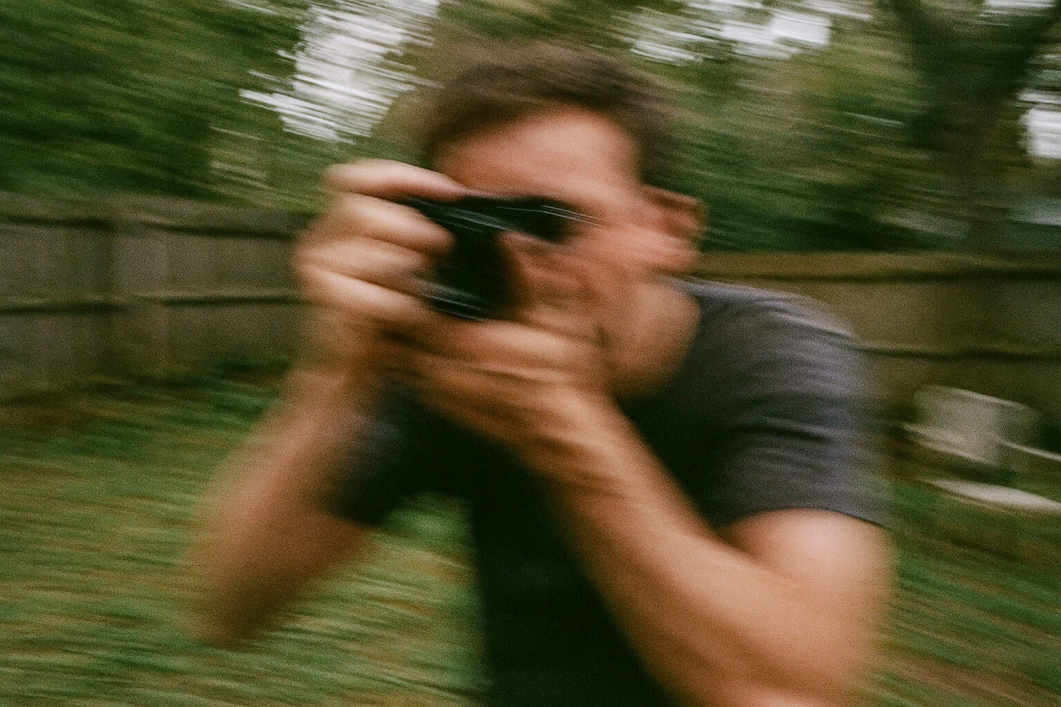 A person making sudden movements with a camera, scaring birds away.